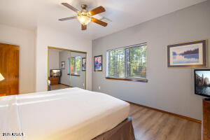 5829 East Buck Springs Road, Unit 252 Pinetop, AZ 85935 - Photo 9 of 27 a bedroom with a bed and a chandelier