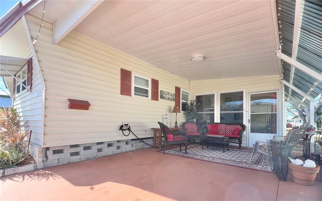 1100 South Belcher Road, Unit 113 Largo, FL 33771 - Photo 11 of 66 a backyard of a house with barbeque oven table and chairs