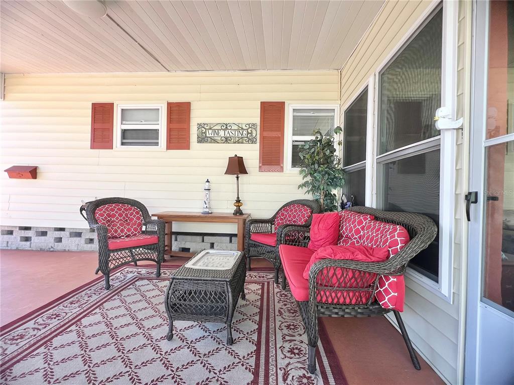 1100 South Belcher Road, Unit 113 Largo, FL 33771 - Photo 12 of 66 a outdoor living space with furniture and a rug