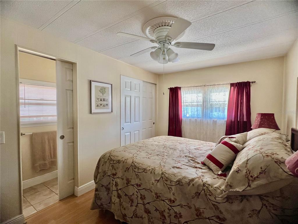 1100 South Belcher Road, Unit 113 Largo, FL 33771 - Photo 16 of 66 a bedroom with a large bed and a chandelier