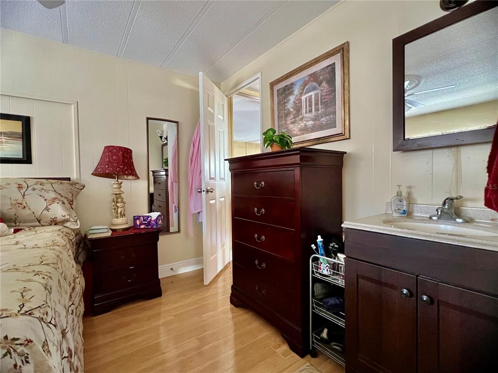 1100 South Belcher Road, Unit 113 Largo, FL 33771 - Photo 19 of 66 a bedroom with a bed and a dresser