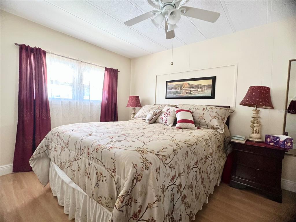1100 South Belcher Road, Unit 113 Largo, FL 33771 - Photo 21 of 66 a bedroom with a large bed and a chandelier