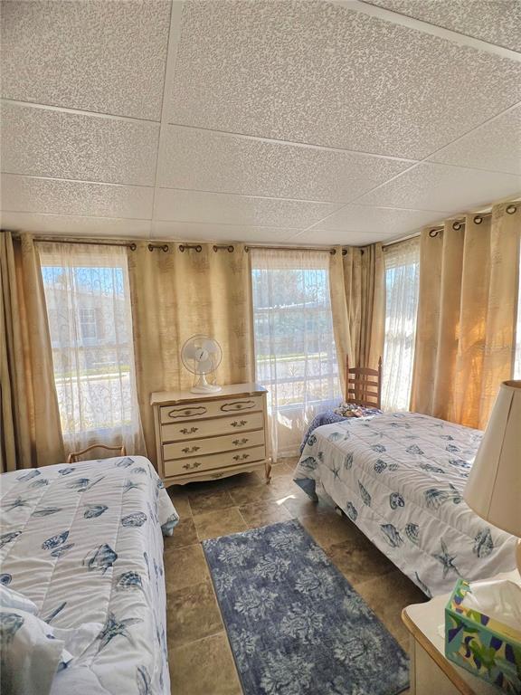 1100 South Belcher Road, Unit 113 Largo, FL 33771 - Photo 23 of 66 a bedroom with a bed wooden floor and window