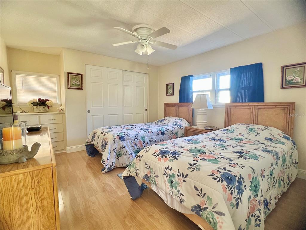 1100 South Belcher Road, Unit 113 Largo, FL 33771 - Photo 26 of 66 a bedroom with a large bed and a chandelier