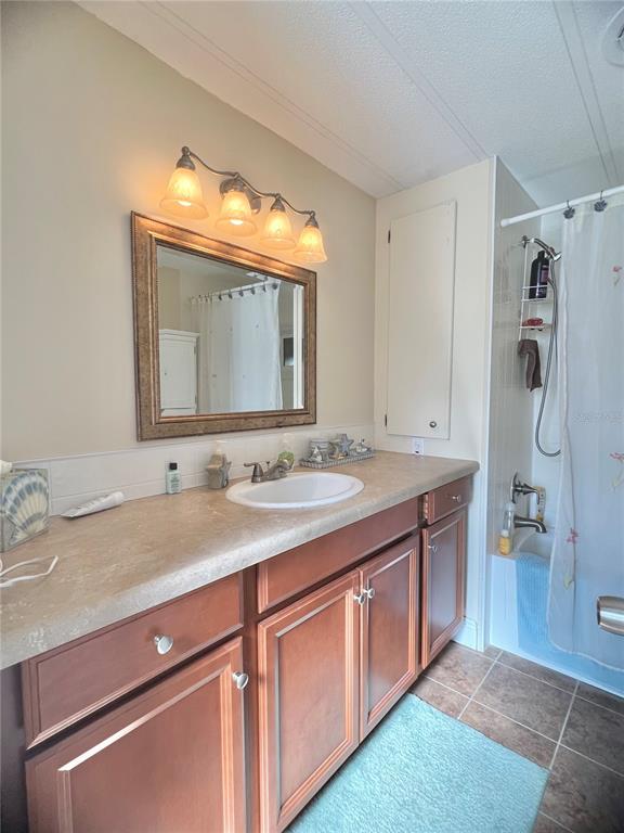 1100 South Belcher Road, Unit 113 Largo, FL 33771 - Photo 28 of 66 a bathroom with a granite countertop sink vanity and mirror