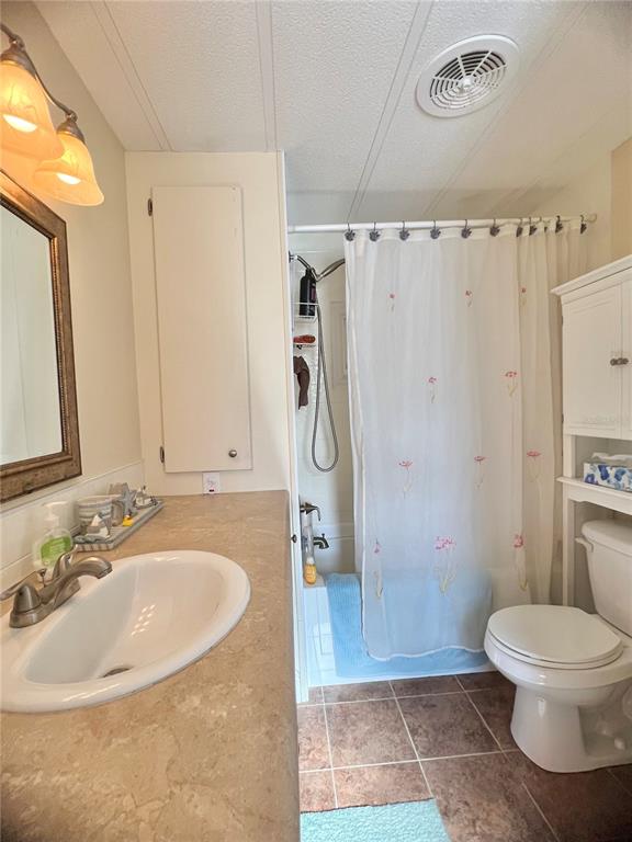 1100 South Belcher Road, Unit 113 Largo, FL 33771 - Photo 29 of 66 a bathroom with a sink a toilet a mirror and shower