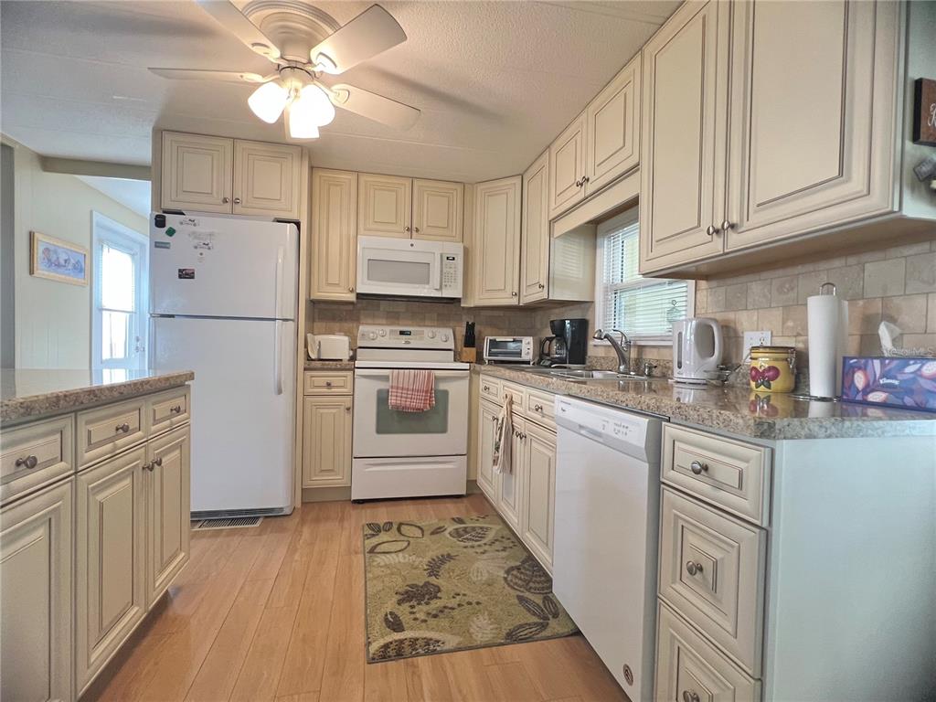 1100 South Belcher Road, Unit 113 Largo, FL 33771 - Photo 36 of 66 a kitchen with cabinets appliances and a counter space