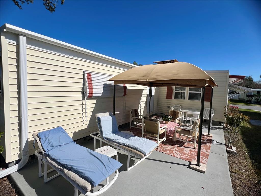1100 South Belcher Road, Unit 113 Largo, FL 33771 - Photo 6 of 66 a outdoor space with patio the couches and a potted plant