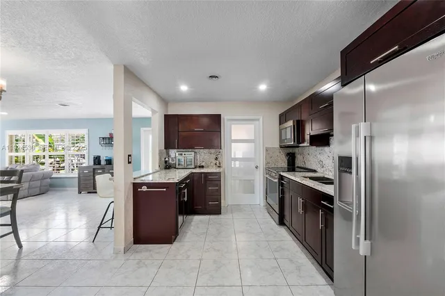 a large kitchen with stainless steel appliances lots of counter top space