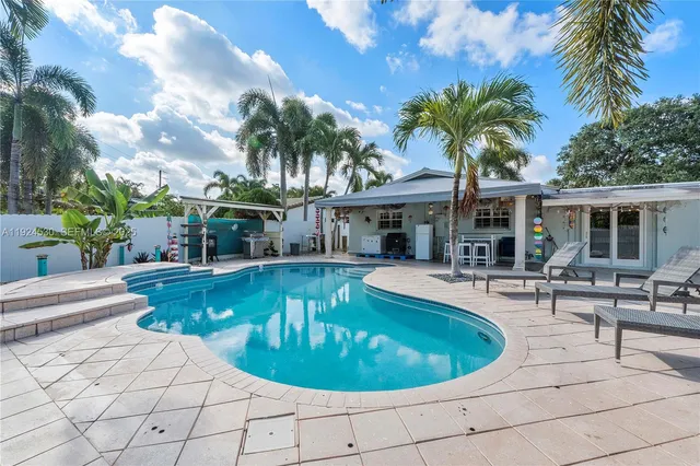 a view of a swimming pool with chairs