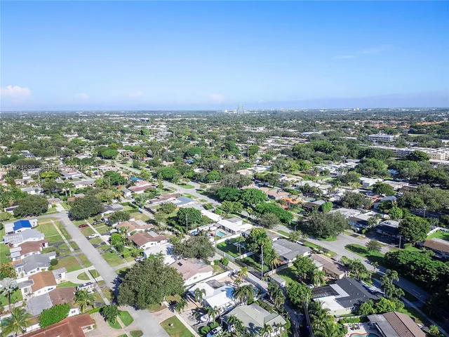an aerial view of residential houses with city view