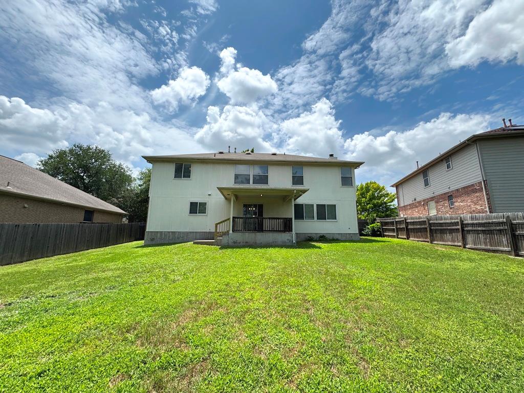 1009 Rutgers Drive Pflugerville, TX 78660 - Photo 39 of 40 A spacious backyard with vibrant green grass, offering a private setting for outdoor enjoyment.