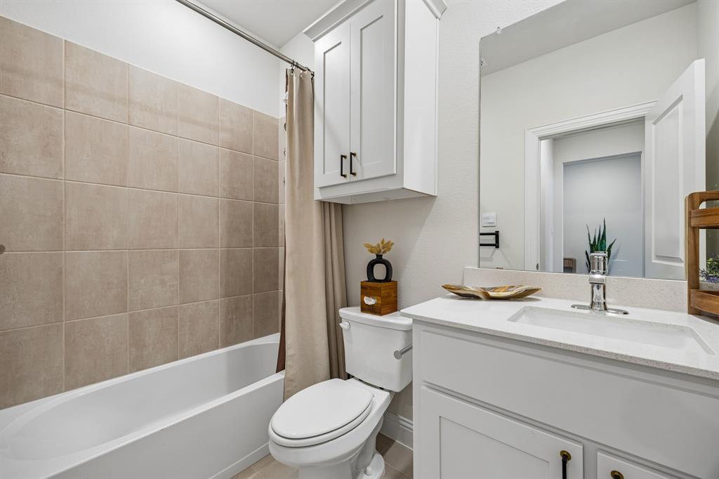 425 Breeds Hl Road Little Elm, TX 75068 - Photo 18 of 38 a bathroom with a sink a toilet and shower