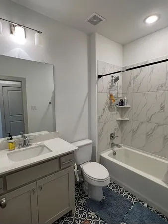 a bathroom with a sink toilet and shower