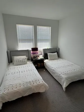 a bedroom with a bed and window