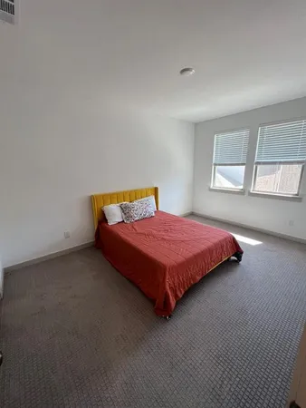 a bedroom with a bed and window