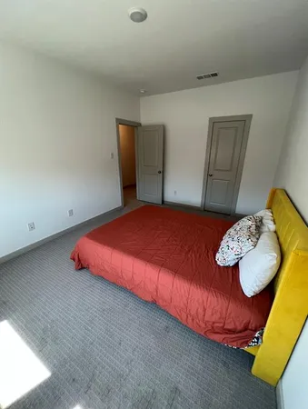 a bedroom with a bed and dresser
