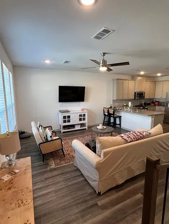a living room with fireplace furniture and a flat screen tv