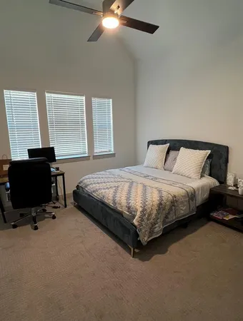 a bedroom with a bed and a desk