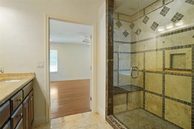 a bathroom with a shower and a sink