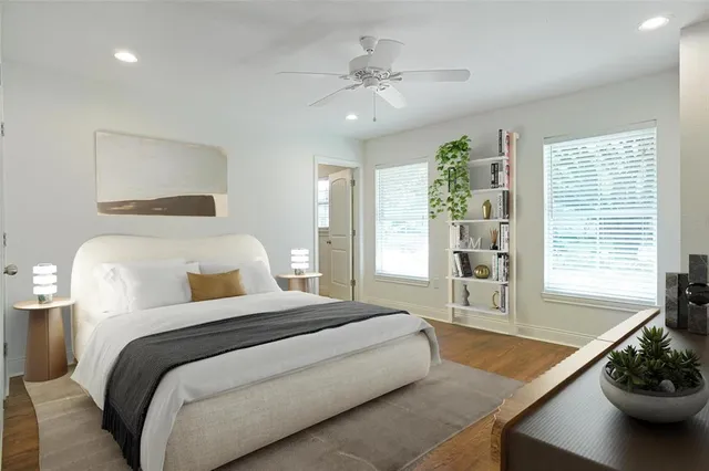 a bedroom with a bed and a large window