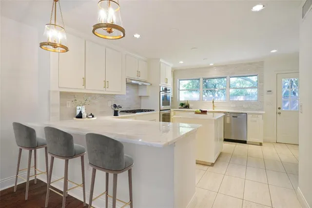 a kitchen with a sink cabinets and window