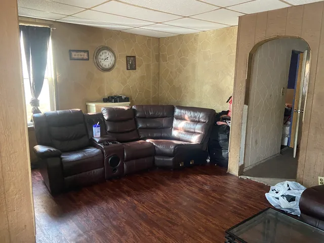 a view of living room with furniture and wooden floor