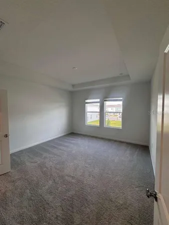 an empty room with a window and a fireplace