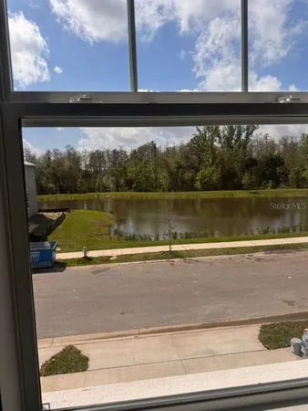 a view of a living room with a floor to ceiling window