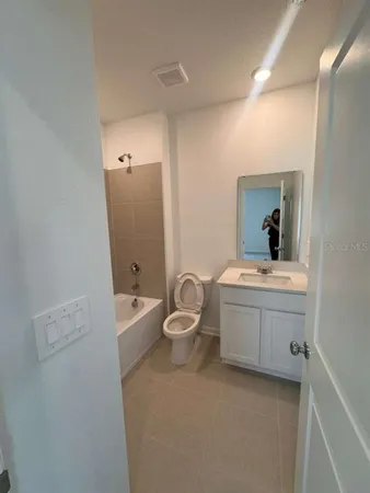 a bathroom with a sink a toilet and mirror