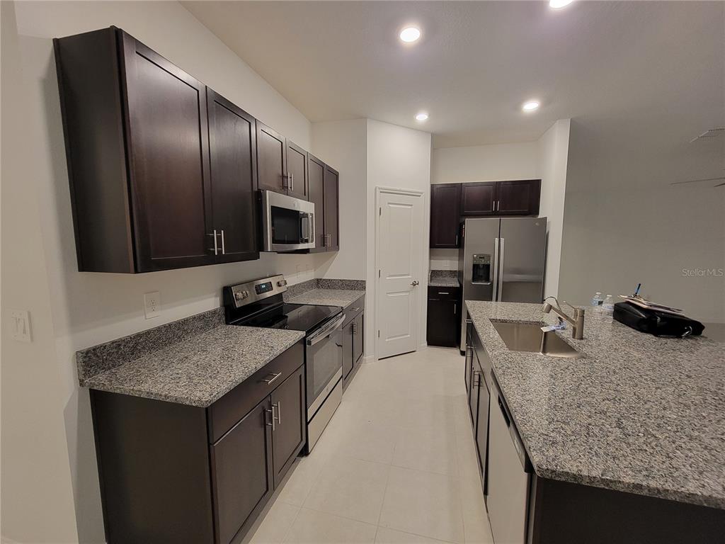 1844 Red Loop Lakeland, FL 33801 - Photo 7 of 24 a kitchen with stainless steel appliances granite countertop a sink stove and refrigerator