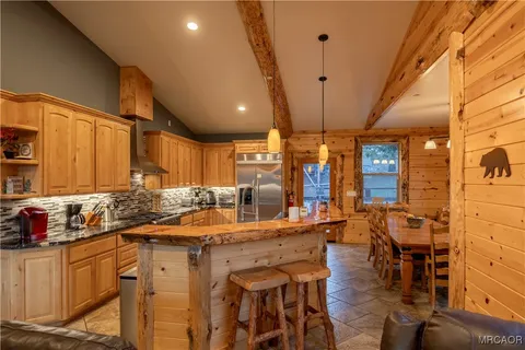 a kitchen with stainless steel appliances granite countertop a sink and cabinets