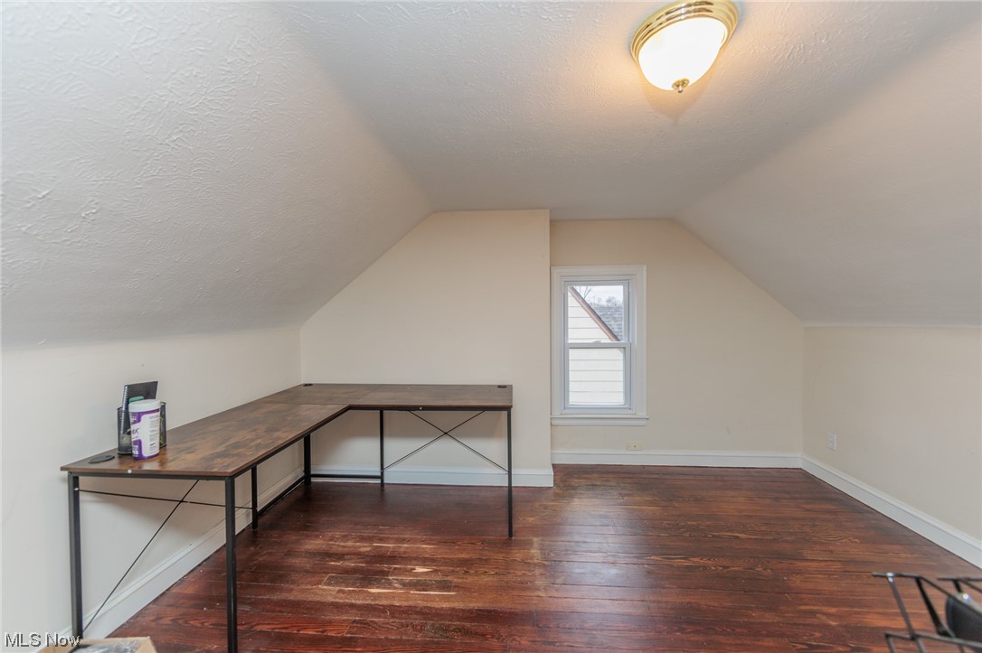 2199 Cranston Road Cleveland, OH 44118 - Photo 29 of 40 Bonus room with a textured ceiling, dark wood-type flooring, and lofted ceiling