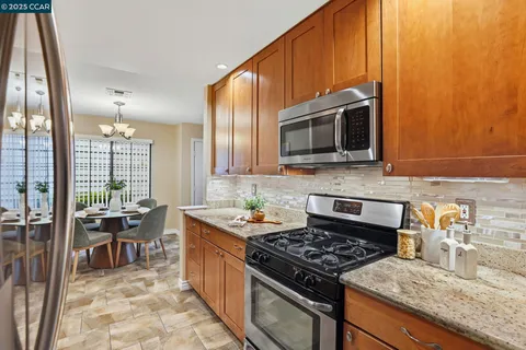 a kitchen with stainless steel appliances a sink cabinets and a refrigerator