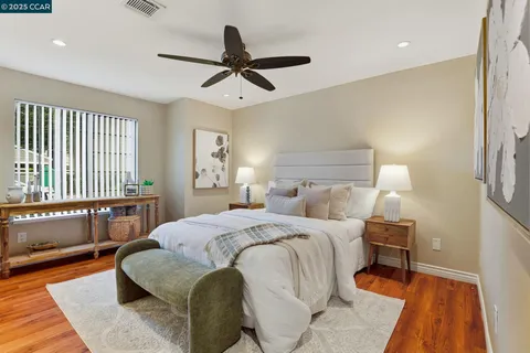 a bedroom with a large bed and a window