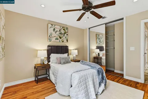 a bedroom with a large bed and a chandelier