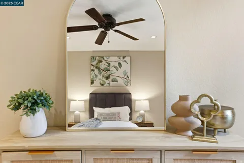 a view of a patio with couches table and chairs and potted plants