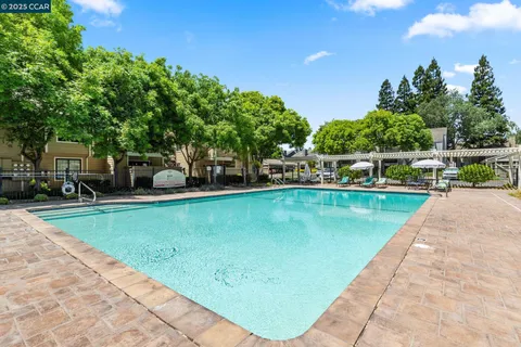 a house with swimming pool in front of it
