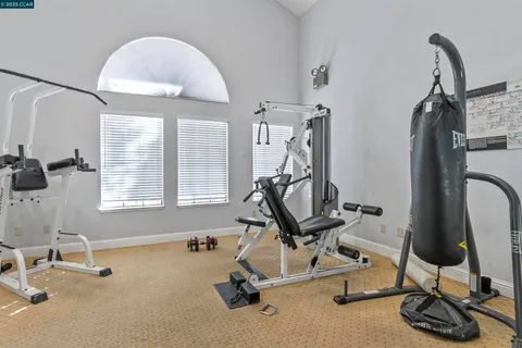 a room with gym equipment and mirrors