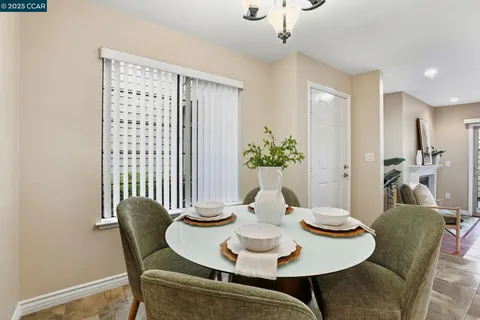a dining room with furniture and window