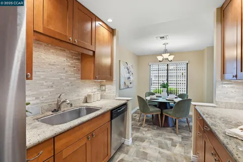 a kitchen with stainless steel appliances a stove a sink and a microwave