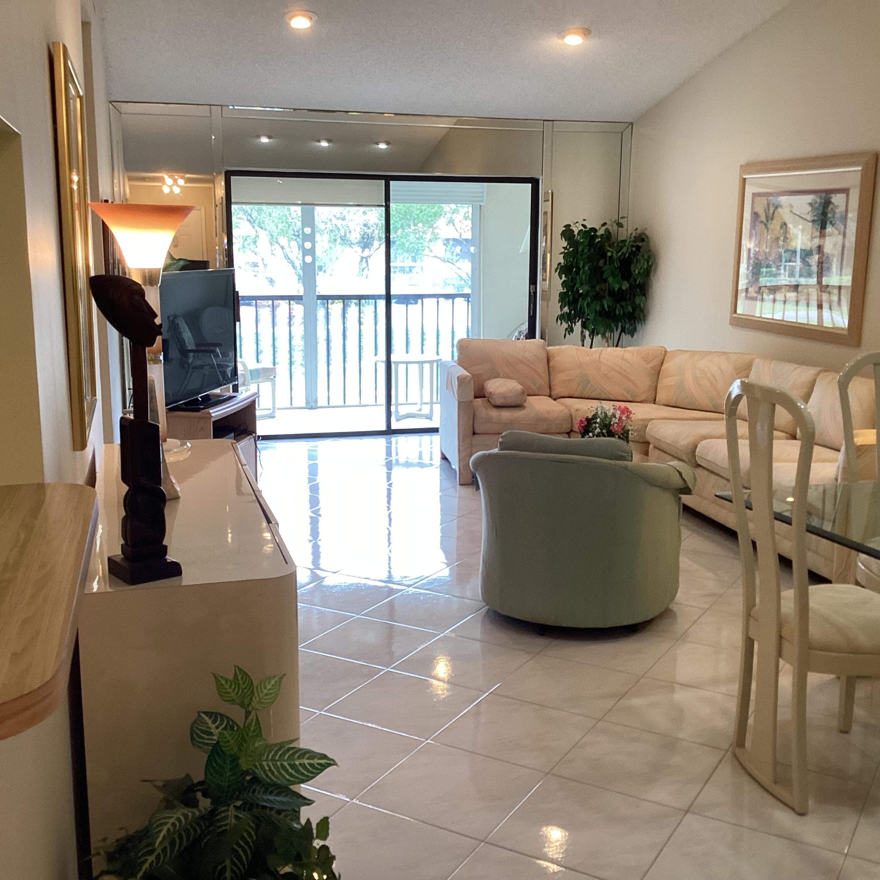 15235 Lakes Of Delray Boulevard, Unit 303 Delray Beach, FL 33484 - Photo 11 of 24 a living room with furniture and a large window