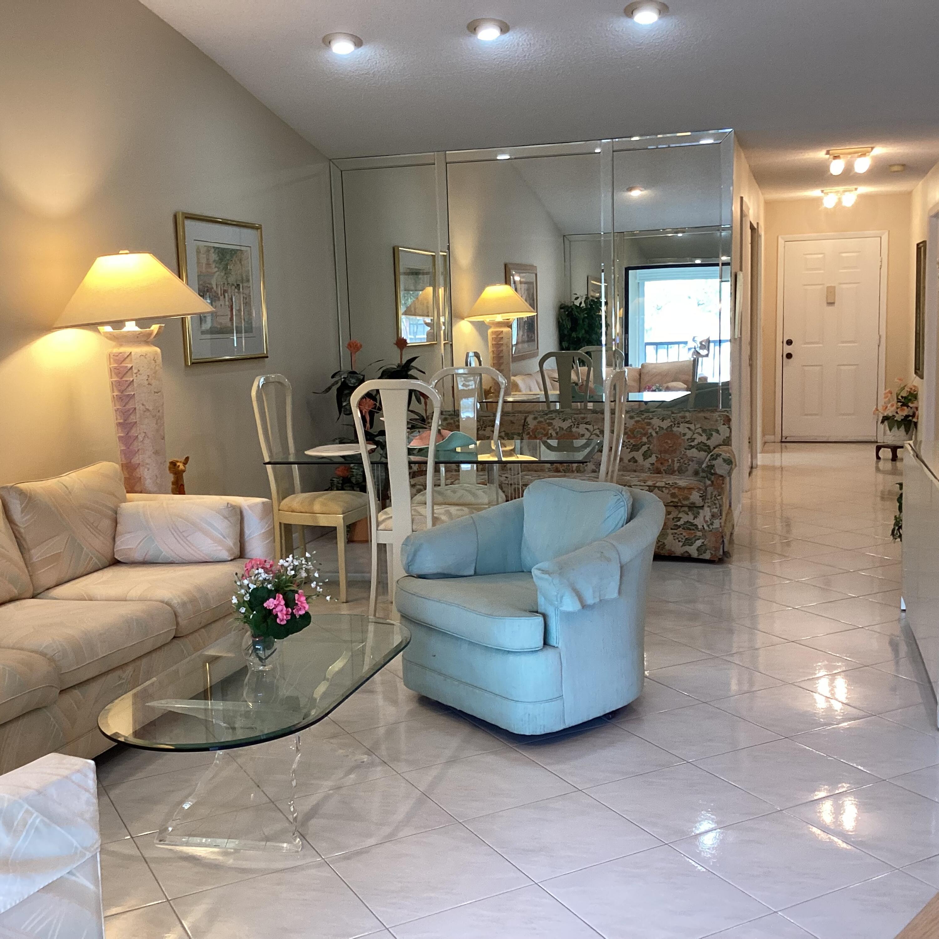 15235 Lakes Of Delray Boulevard, Unit 303 Delray Beach, FL 33484 - Photo 13 of 24 a living room with furniture and a chandelier