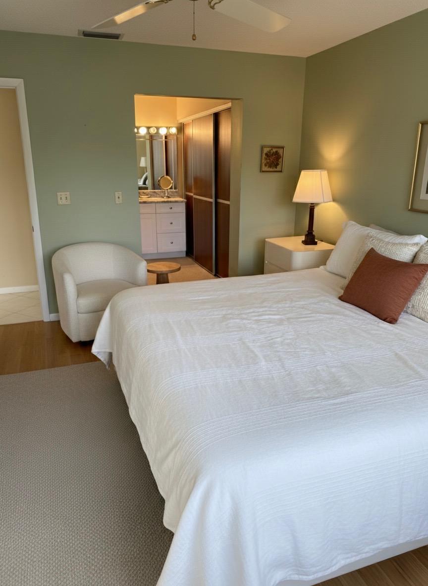 15235 Lakes Of Delray Boulevard, Unit 303 Delray Beach, FL 33484 - Photo 14 of 24 a bedroom with a bed and lamp