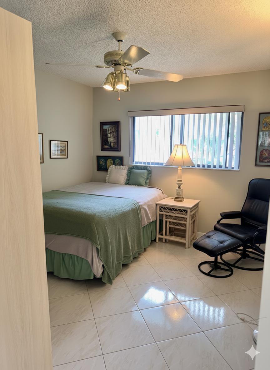 15235 Lakes Of Delray Boulevard, Unit 303 Delray Beach, FL 33484 - Photo 16 of 24 a bedroom with a bed furniture and a window