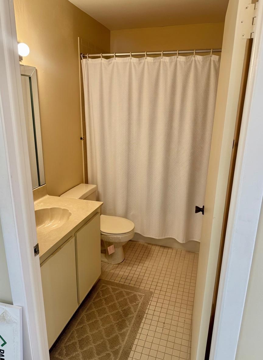 15235 Lakes Of Delray Boulevard, Unit 303 Delray Beach, FL 33484 - Photo 17 of 24 a bathroom with a granite countertop sink and a mirror