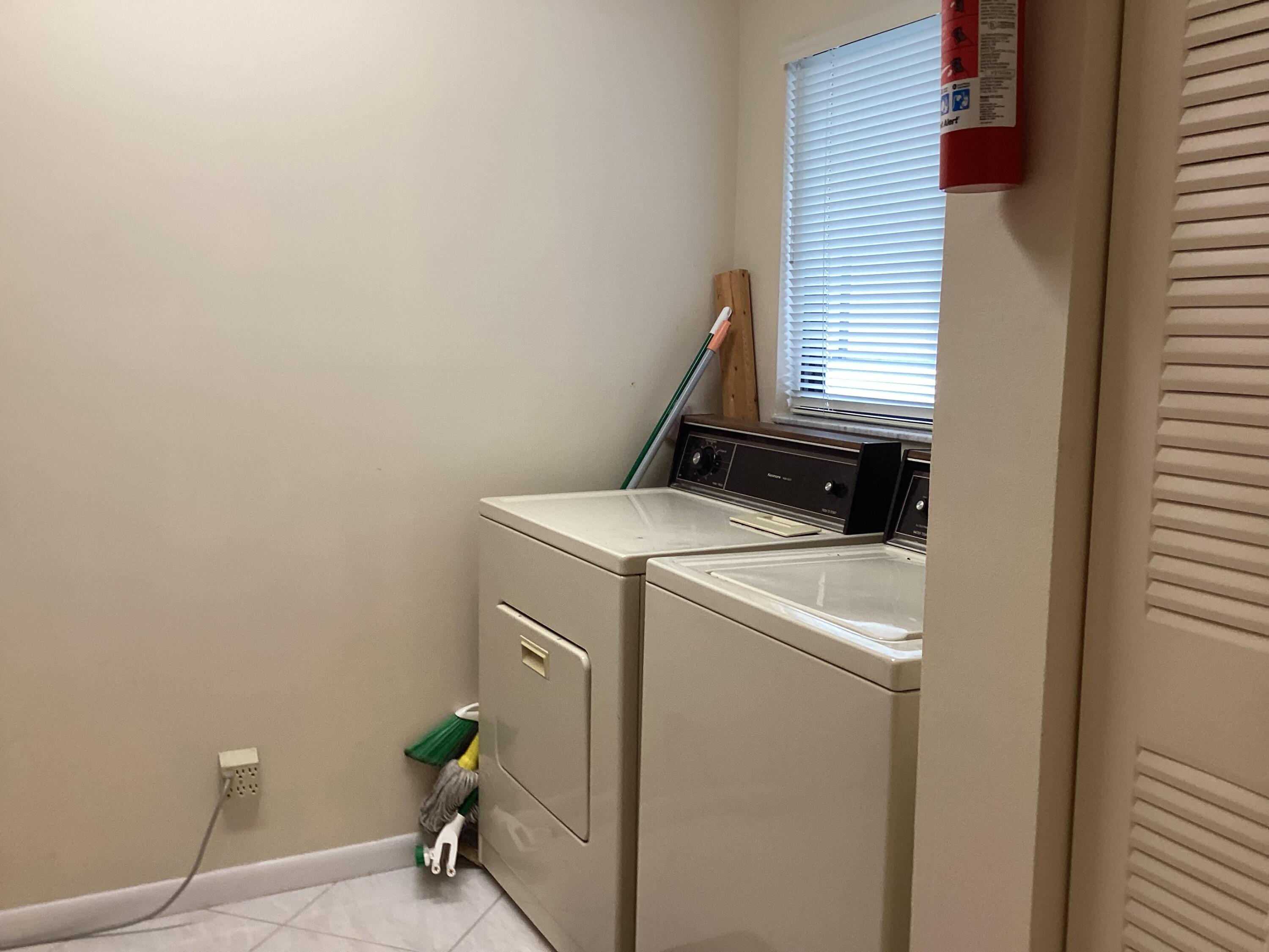 15235 Lakes Of Delray Boulevard, Unit 303 Delray Beach, FL 33484 - Photo 19 of 24 a utility room with dryer and washer