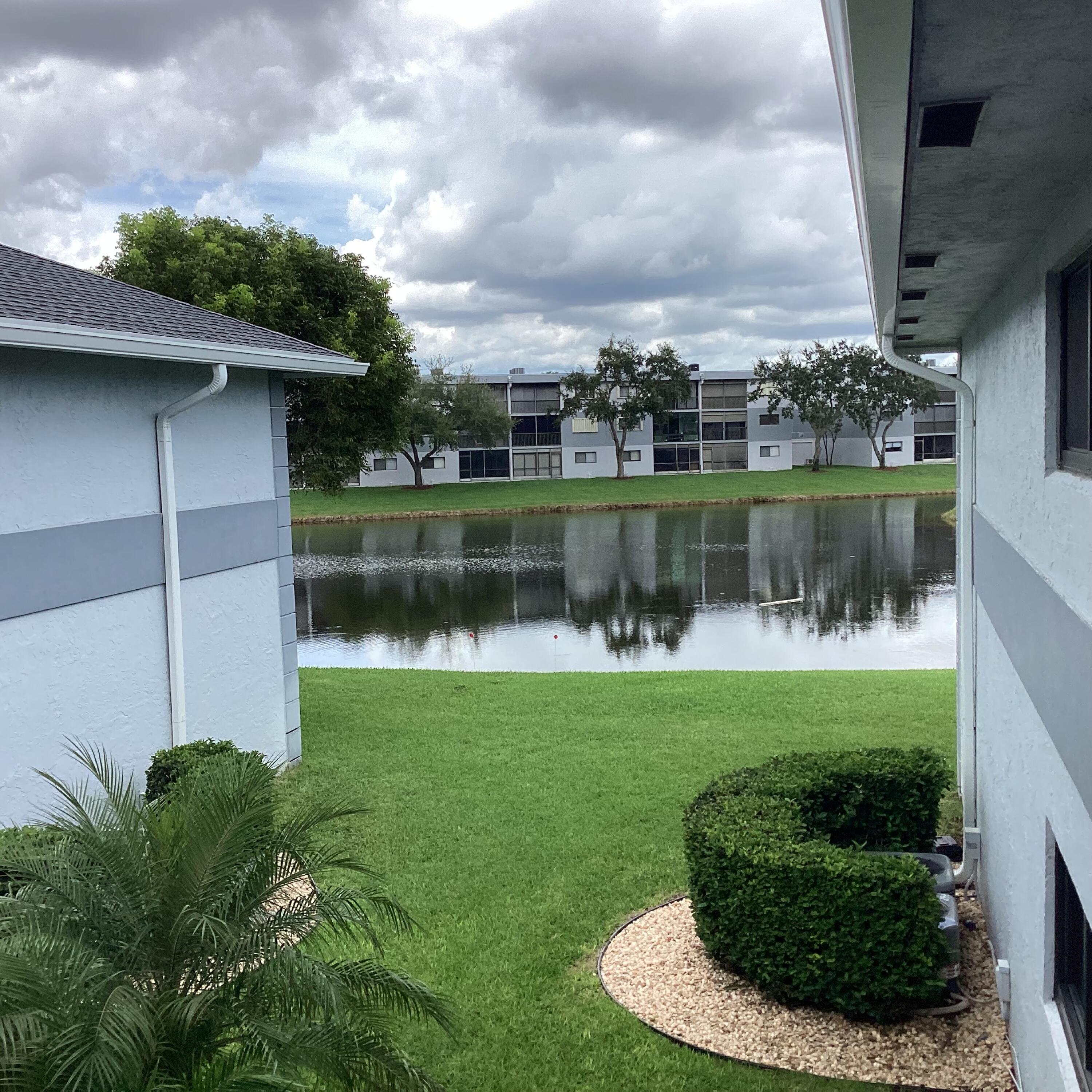 15235 Lakes Of Delray Boulevard, Unit 303 Delray Beach, FL 33484 - Photo 2 of 24 a view of a lake with a garden