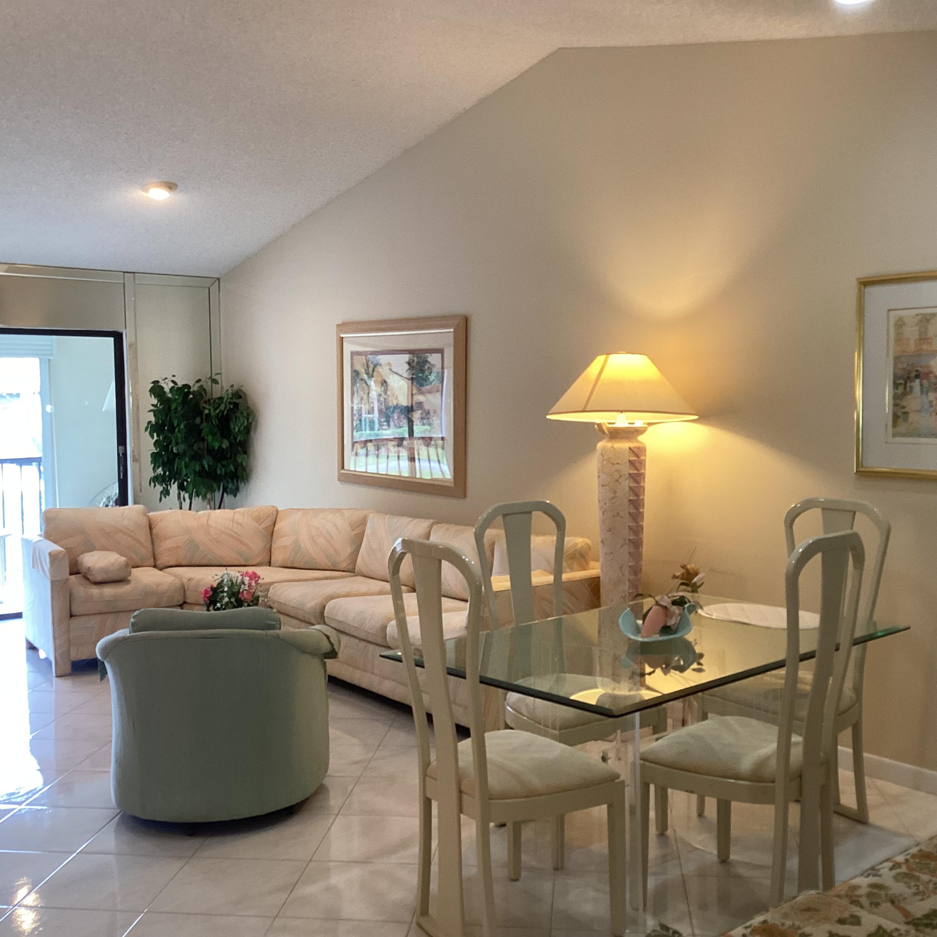 15235 Lakes Of Delray Boulevard, Unit 303 Delray Beach, FL 33484 - Photo 7 of 24 a living room with furniture a table and chair