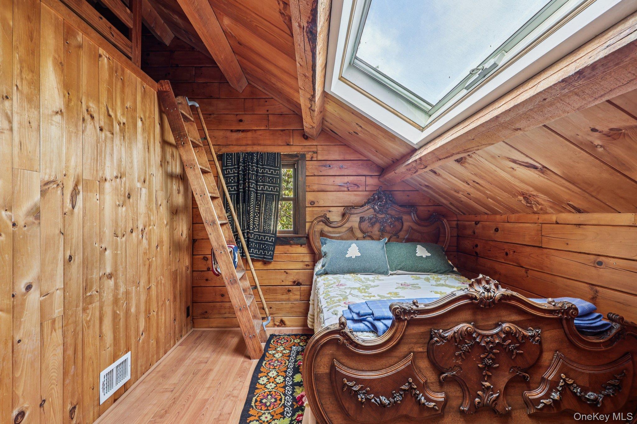 101 Upper Wisner Road Warwick, NY 10990 - Photo 17 of 48 Bedroom featuring wood walls, wooden ceiling, wood finished floors, and a skylight